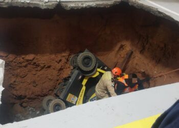 Empilhadeira é engolida por cratera e equipes de resgate são acionadas
